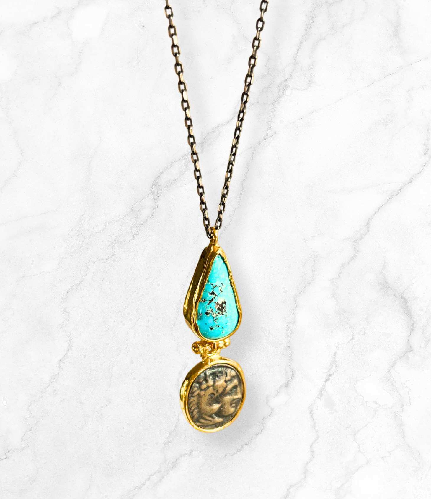 Turquoise coin necklace featuring an ancient Roman coin and a diamond-shaped turquoise stone on a silver chain.