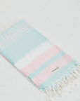 A lightweight peshtemal towel in mint and light pink