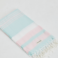 A lightweight peshtemal towel in mint and light pink