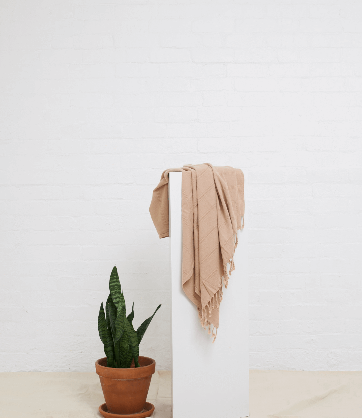 Stonewash Turkish Towel hanging over pedestal