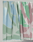 Pastel coloured Turkish Beach Towels featuring leaf patterns in blue, green, and pink