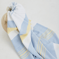 A lightweight peshtemal towel in light yellow and blue