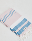 A lightweight peshtemal towel in light pink and blue