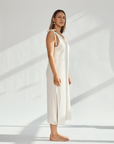 Elegant soft cotton dress with tied straps and leg slits, showcasing breathable style and comfort.