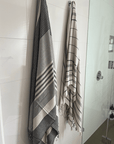 Two premium linen "Kekova" Turkish towel hanging on bathroom wall