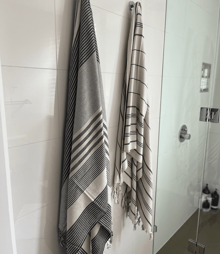 Two premium linen "Kekova" Turkish towel hanging on bathroom wall