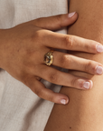 A close-up of a hand wearing a Green Amethyst Gold Ring, showcasing its elegance and craftsmanship.