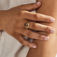 A close-up of a hand wearing a Green Amethyst Gold Ring, showcasing its elegance and craftsmanship.