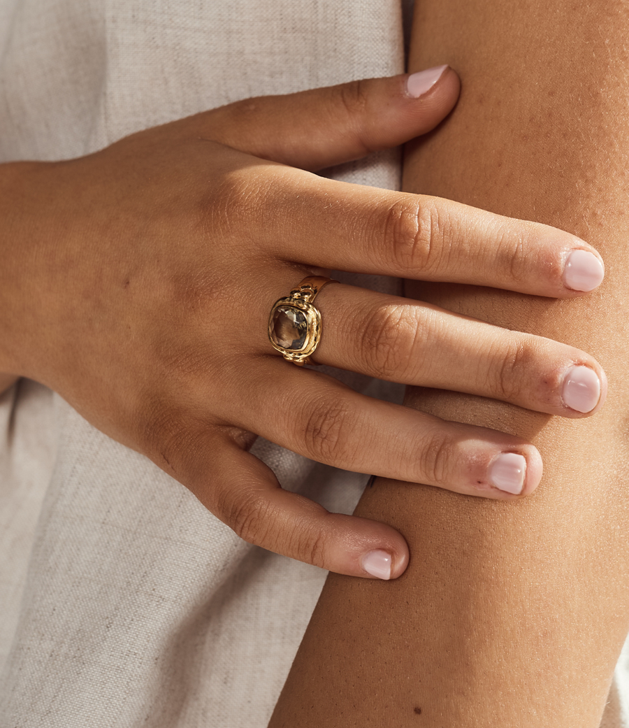 A close-up of a hand wearing a Green Amethyst Gold Ring, showcasing its elegance and craftsmanship.