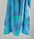 Turkish Beach Towel with an abstract wave design in shades of blue and turquoise, showcasing a vibrant coastal aesthetic.
