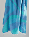Turkish Beach Towel with an abstract wave design in shades of blue and turquoise, showcasing a vibrant coastal aesthetic.