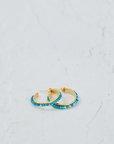 Turquoise hoop earrings made with beads and 18k gold plated sterling silver hoops, showcasing elegant craftsmanship.