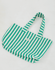 Herringbone woven linen tote bag in Green stripe layed flat on floor