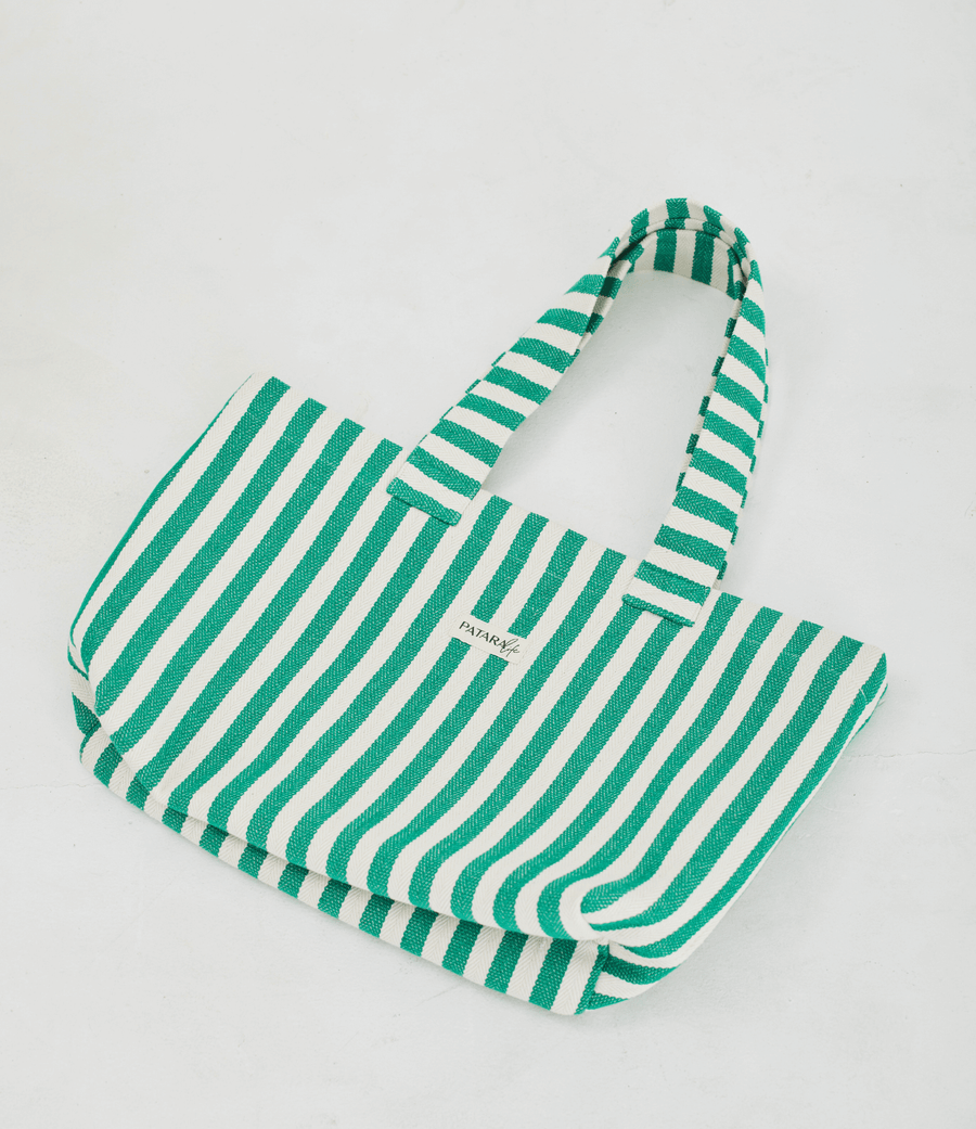 Herringbone woven linen tote bag in Green stripe layed flat on floor