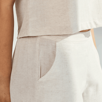 Close-up of a person wearing linen wide leg pants, showcasing the soft fabric and relaxed fit.
