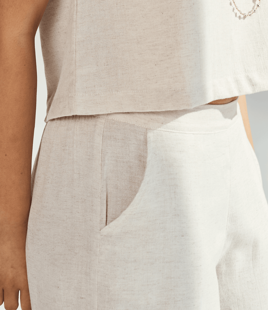 Close-up of a person wearing linen wide leg pants, showcasing the soft fabric and relaxed fit.