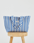 Blue stripe beach tote bag on top of stool