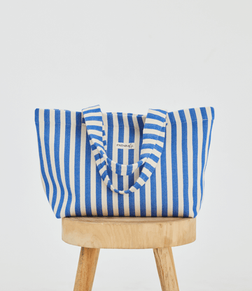 Blue stripe beach tote bag on top of stool
