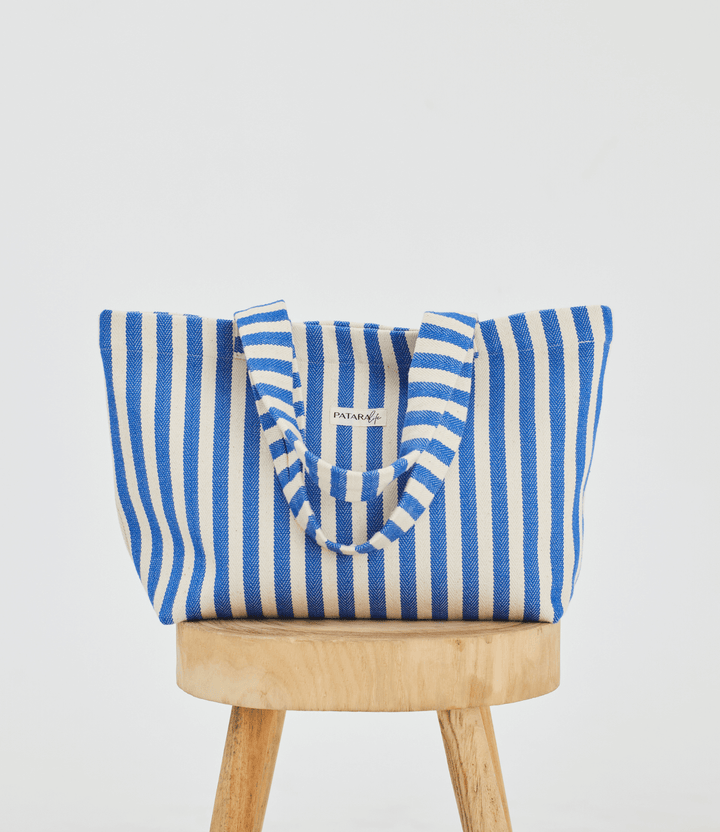 Blue stripe beach tote bag on top of stool
