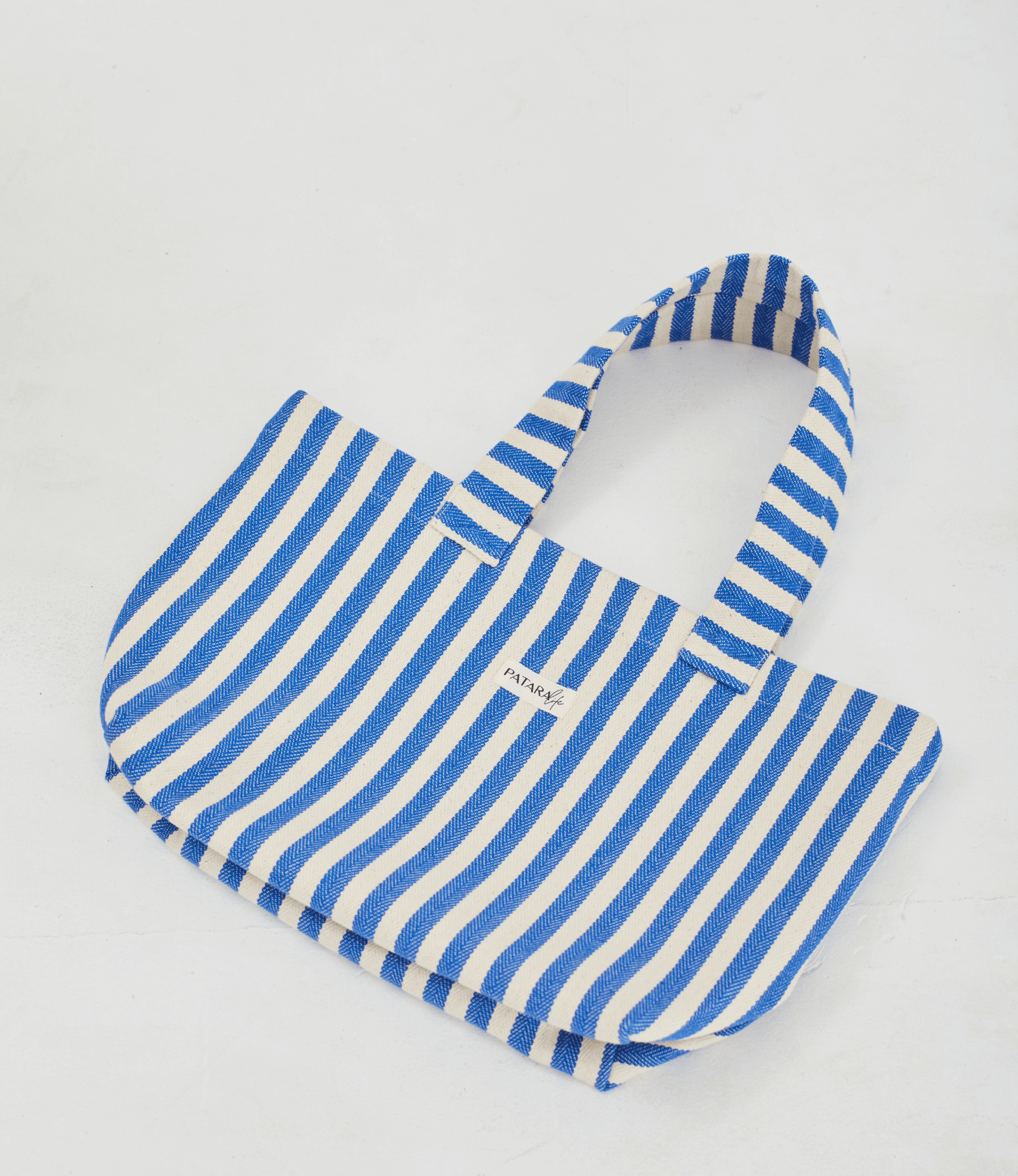 Blue stripe beach tote bag layed flat on floor