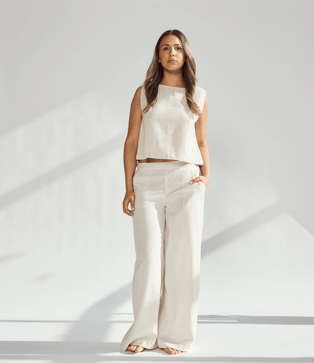 Model wearing a beige linen wide leg and crop top set, highlighting comfort and sophistication in fashion.