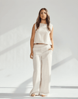 Model wearing a beige linen wide leg and crop top set, highlighting comfort and sophistication in fashion.