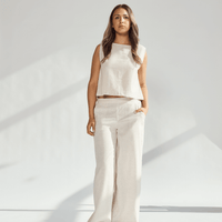 Model wearing a beige linen wide leg and crop top set, highlighting comfort and sophistication in fashion.