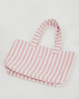 Herringbone woven linen tote bag in Light Pink layed flat on floor 