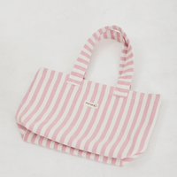 Herringbone woven linen tote bag in Light Pink layed flat on floor 