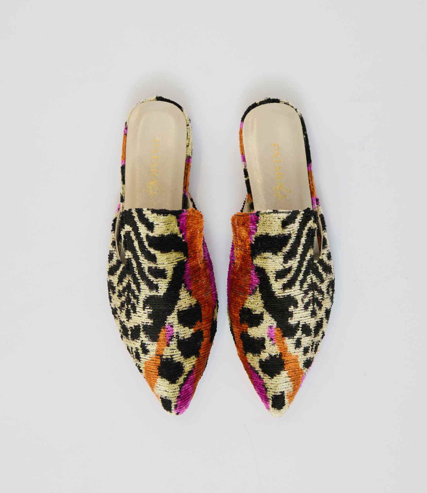 Pair of colorful patterned slippers on a light gray background
