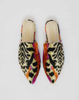 Pair of colorful patterned slippers on a light gray background