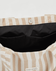 Inside look at Herringbone woven linen tote bag showing black lining and pockets