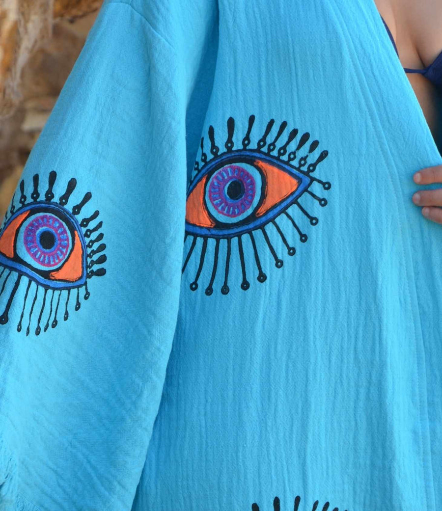 Evil Eye Kaftan Robe in turquoise featuring hand-painted eye designs, perfect for stylish loungewear or beachwear.