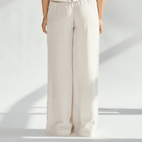 Back view of elegant linen wide leg pants in light beige, showcasing a flowing silhouette and comfortable fit.