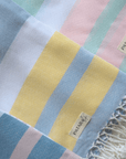 Three lightweight peshtemal towels folded and layed flat on top of each other