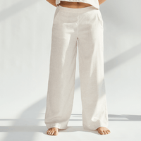 Linen wide leg pants in a light beige color, offering a relaxed fit and graceful silhouette for sophisticated style.