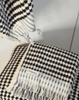 Pearl Turkish cotton hand towel in black and white, featuring traditional knotting techniques for a luxurious feel.