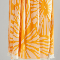 Radiance Turkish beach towel featuring a sunburst pattern in golden yellow and soft orange hues.