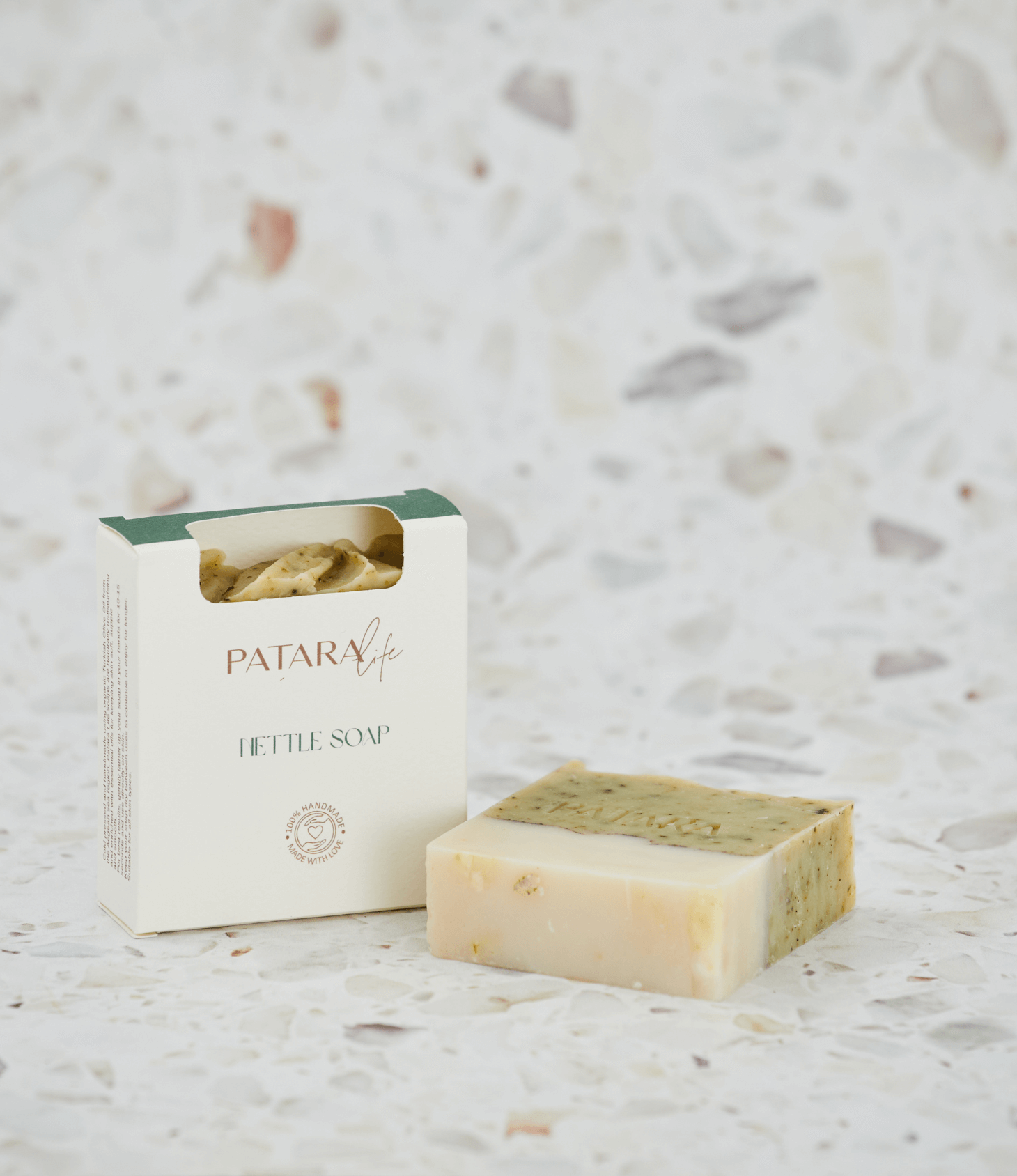 Nettle Cold Pressed Olive Oil Soap Bar by Patara, showcased with its packaging and a textured background.