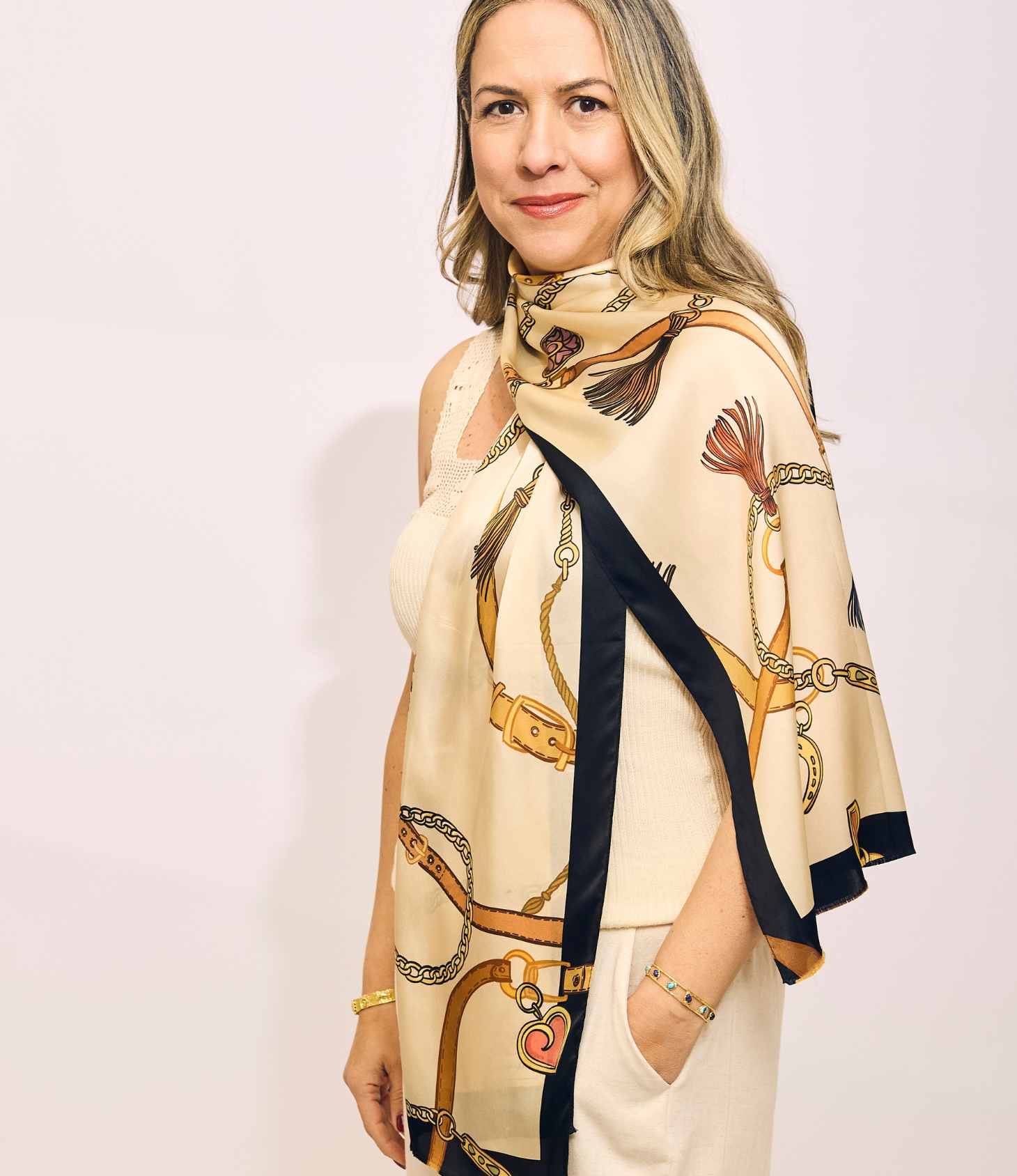 Woman wearing a patterned scarf with a plain background