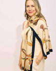 Woman wearing a patterned scarf with a plain background