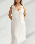 Elegant soft cotton dress with tied straps and subtle leg slits, perfect for refined and comfortable wear.