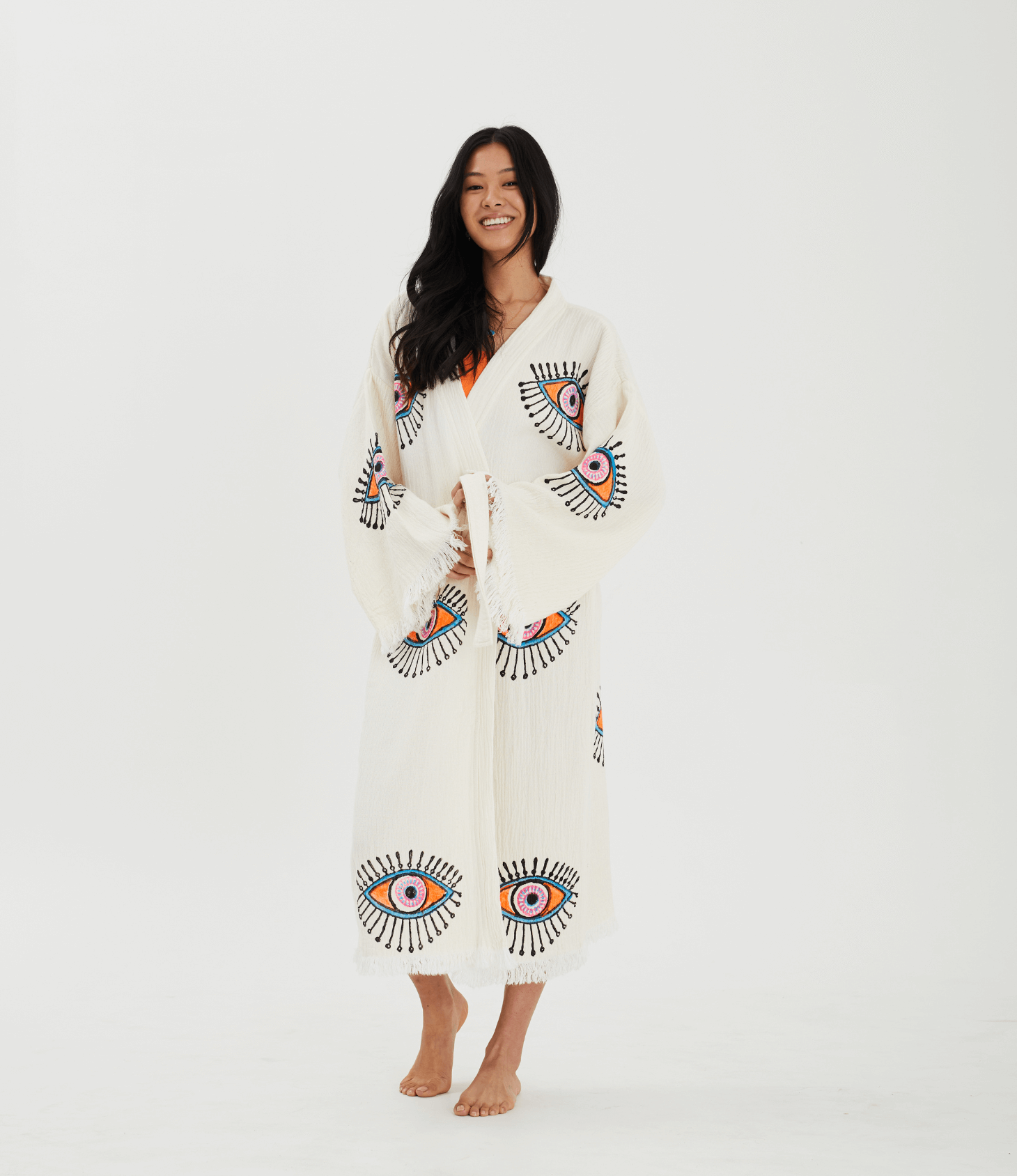 Model wearing a handcrafted Evil Eye Robe made of Buldan muslin cotton, featuring vibrant handpainted designs.