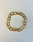 Gold chain bracelet on a light gray background