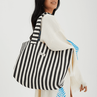 Herringbone woven linen tote bag in Black stripe worn over shoulder