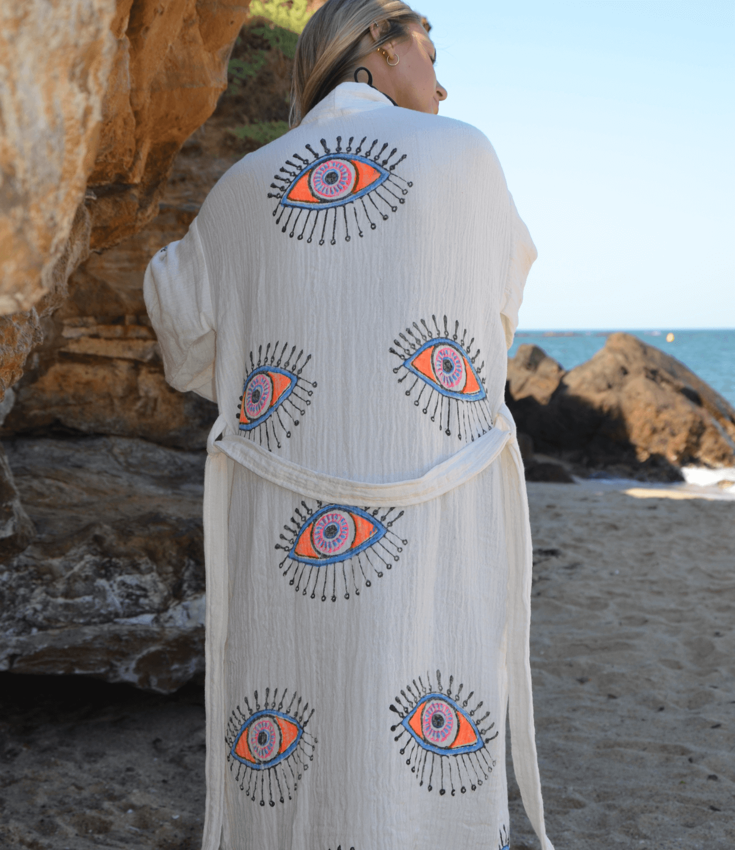 Elegant Evil Eye Robe in soft muslin cotton, featuring handpainted designs, perfect for the beach or as a dressing gown.
