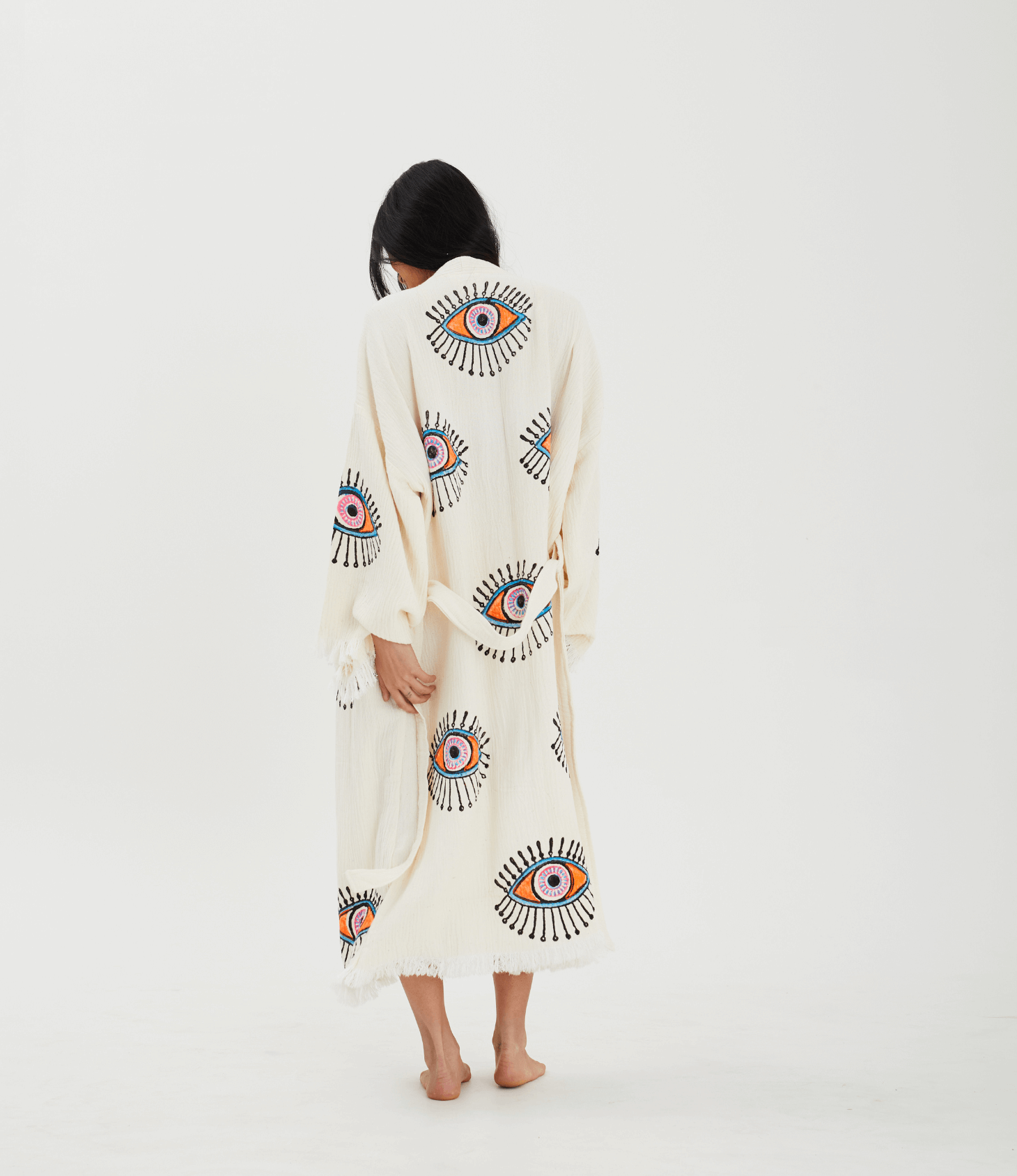 Back view of a woman in an Evil Eye Robe, showcasing handcrafted muslin cotton and traditional stone printing.