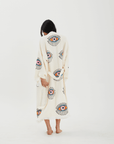 Back view of a woman in an Evil Eye Robe, showcasing handcrafted muslin cotton and traditional stone printing.