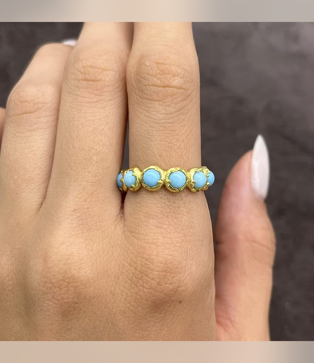 Aegean Five Stone Ring with turquoise-blue accents in gold-tone settings, worn on a hand