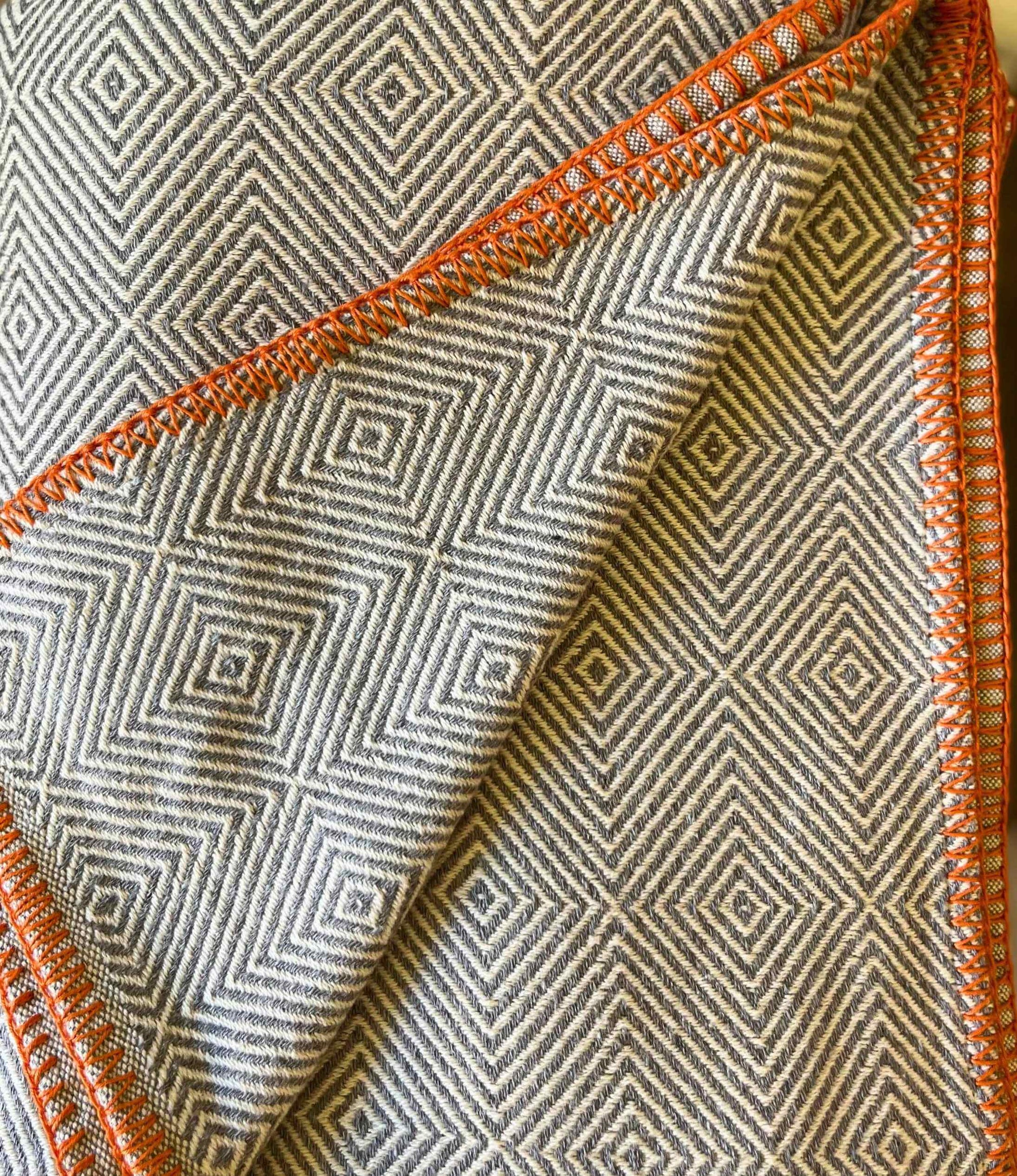 Textile with geometric pattern and orange border
